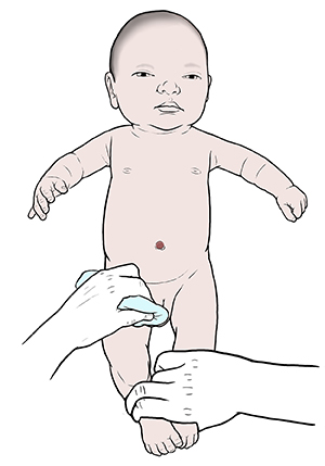 One hand holding newborn baby securely and other hand cleaning baby's penis. 