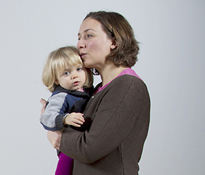 Woman holding toddler girl.