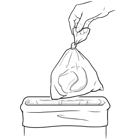 Ostomy bag tied in plastic bag being placed in trash.