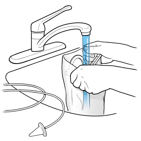 Person holding top of sleeve open and under faucet with running water.