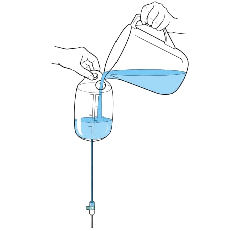 Hand holding bag up and other hand pouring pitcher of water into opening at top of bag.