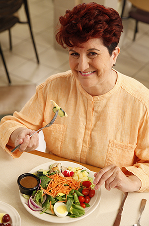 Woman eating salad.