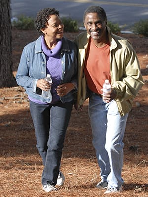 A woman and a man walking.