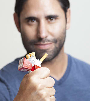 Person crushing cigarettes.