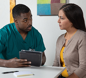 Woman talking to health care provider.