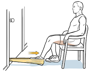 Person sitting on chair with heel in resistance band, doing hamstring curl exercise.