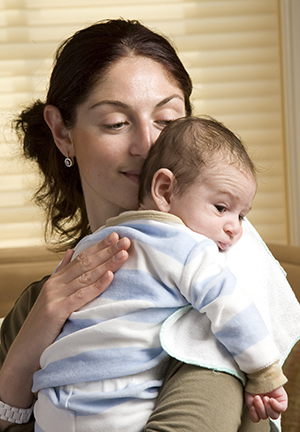 Woman holding newborn baby.